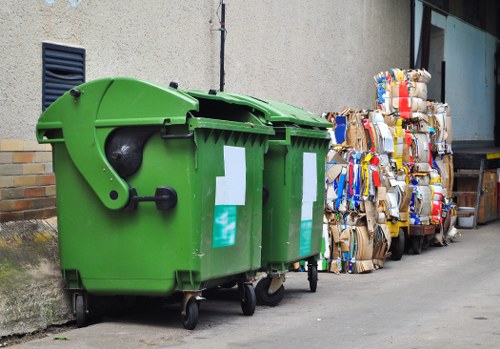 Operative wearing PPE assessing waste at a property
