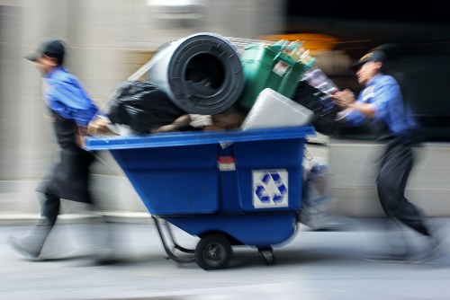 Garden waste being loaded into a skip for removal